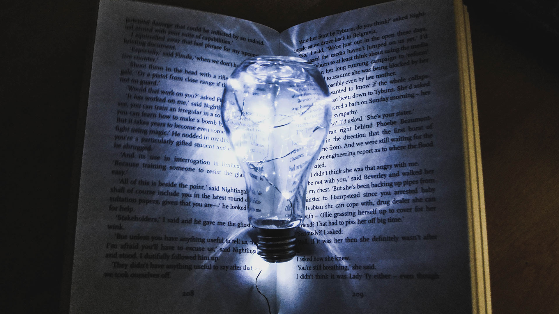 a lightbulb held over an open book