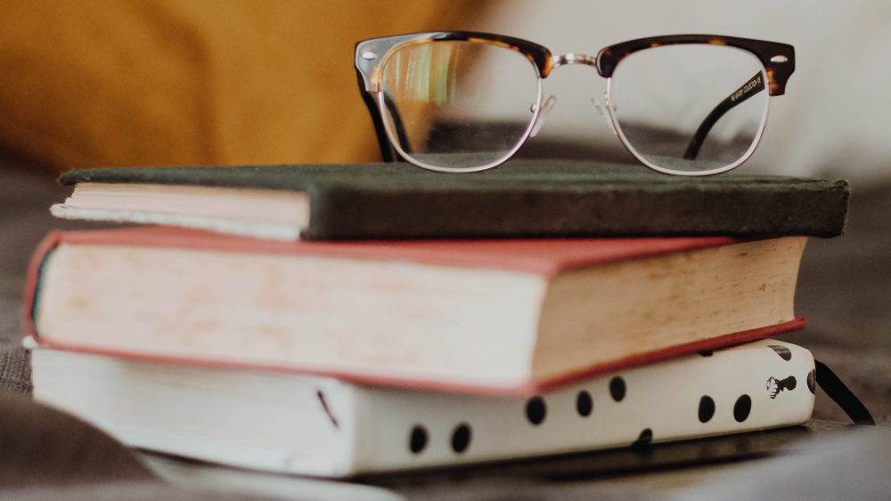 glasses on a stack of books